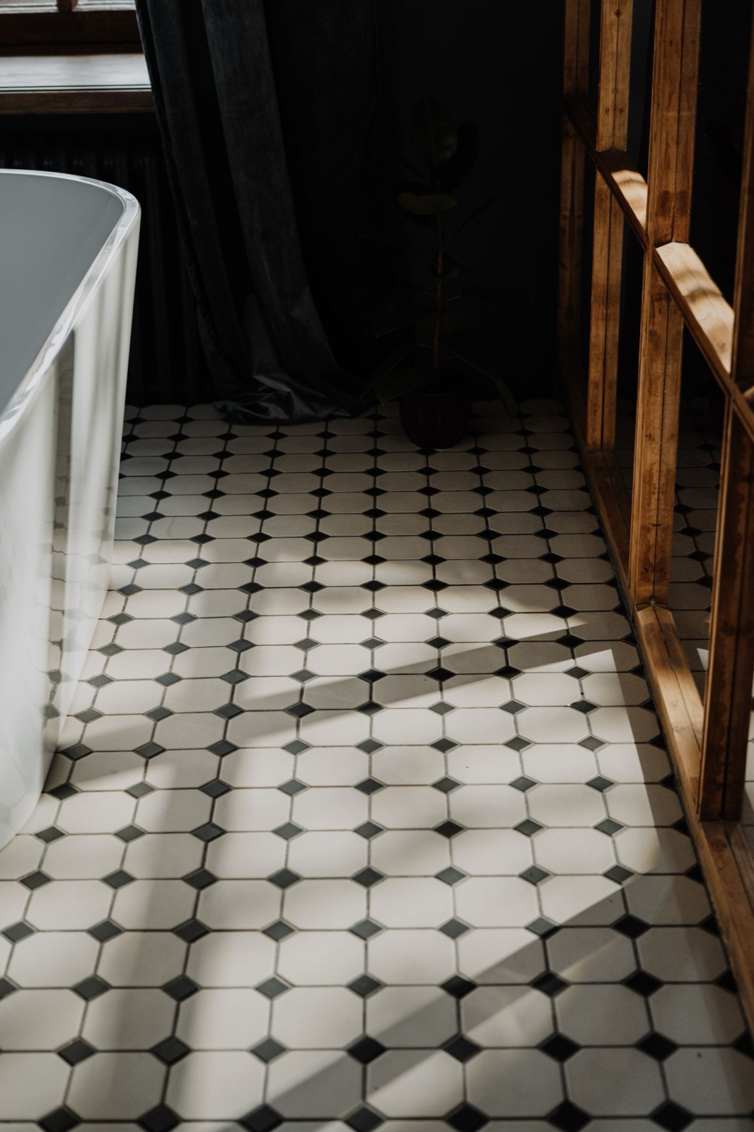 Black-and-white tile-look vinyl floor in a bathroom