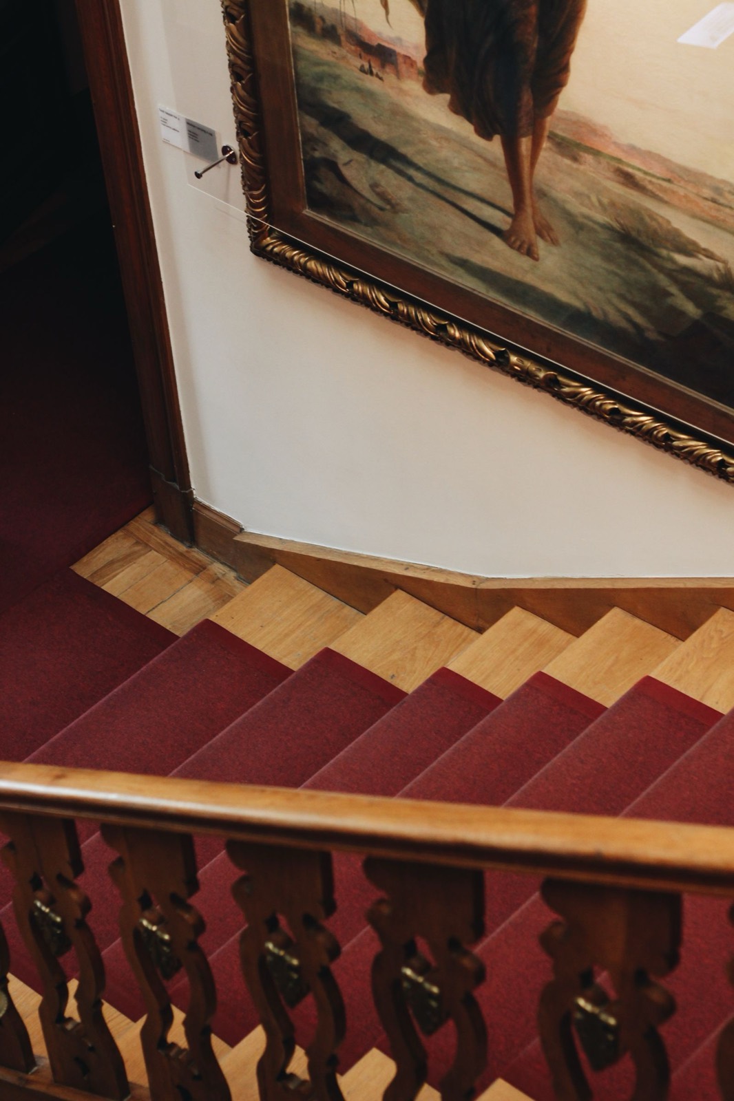 Wood staircase with a center runner, seen from above