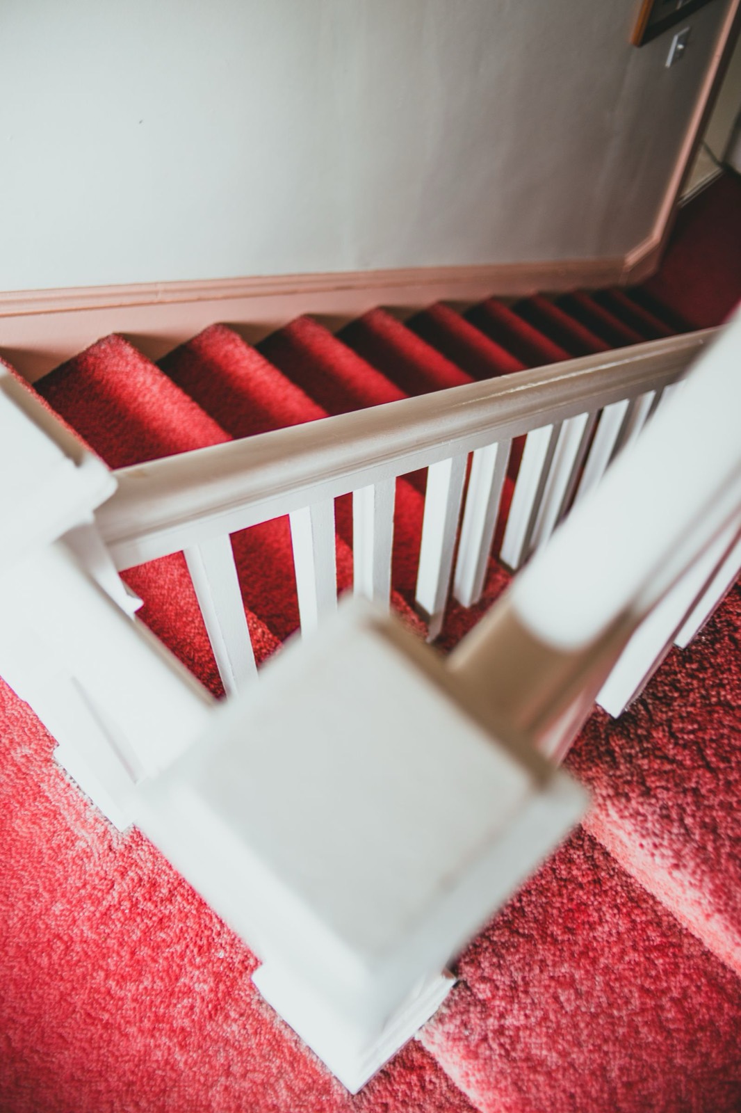 Staircase with a runner and painted risers